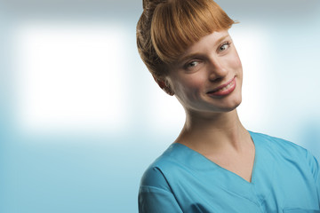 close up on a beautiful young woman nurse or doctor with red hair