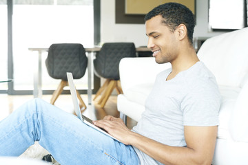 Contemplation at work. Shot of a successful young man using laptop while working from home.