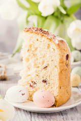 Slice of easter orthodox sweet bread, kulich end quail eggs. Holidays breakfast. Retro style toned.