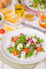 Salad with arugula, squid, cherry tomatoes, onion and quail eggs