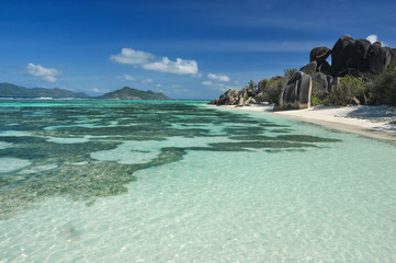 Big granite stones on the white-sand beach next to turquoise water
