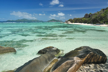 Big granite stones on the white-sand beach next to turquoise water