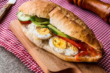 Egg Sandwich with black pepper, tomatoes and greens.