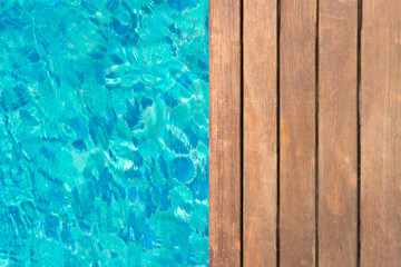 wooden platform at swimming pool with text space