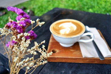 Blurred background of coffee cup and flower.