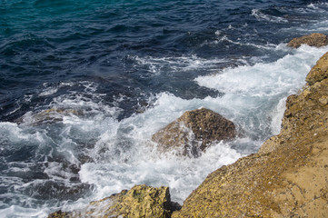 The sea around the breakwater rocks, background.