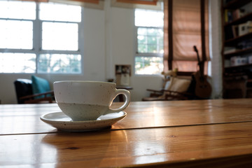 A cup on wooden table in coffee shop