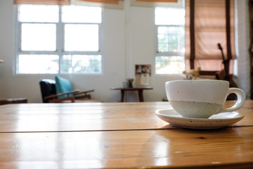 A cup on wooden table in coffee shop