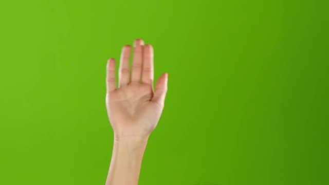 Girl with manicure waving Hello raising hand up. Green screen