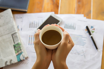 female hands coffee cup on notebook coffee cafe