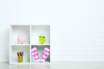 White shelves on a brick wall background