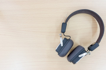 Bluetooth headset on wooden background.