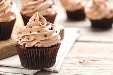 Tasty cupcakes on a grey wooden table