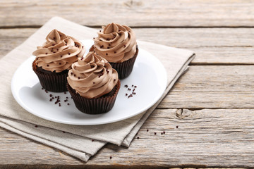Tasty cupcakes on a grey wooden table