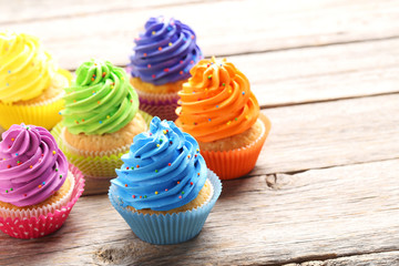 Tasty cupcakes on a grey wooden table