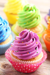 Tasty cupcakes on a grey wooden table