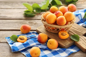 Poster Ripe apricots fruit on grey wooden table © 5second