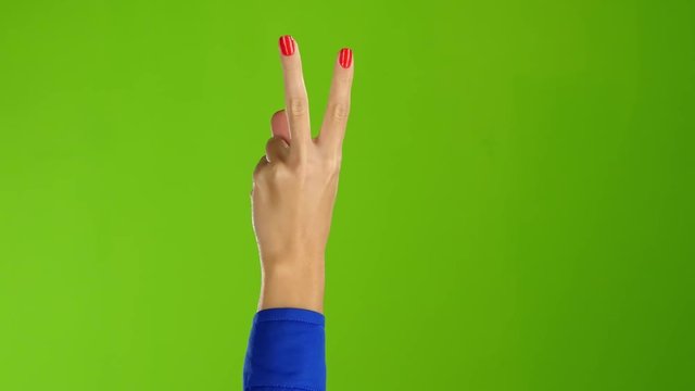 Sign of peace shows arm woman back of the hand