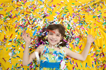 Happy little girl  celebrating party with blowing confetti top view. Child in birthday party, cute girl .