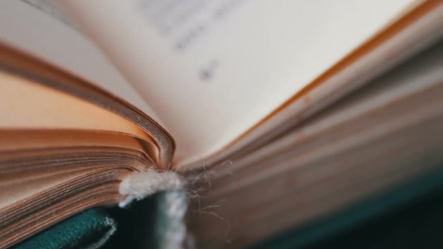 Turning the pages of an old book close-up