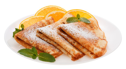Serving pancakes with orange slices on the plate.