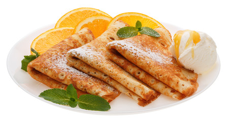 Serving pancakes with ice cream and orange slices on the plate.