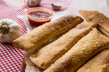 Garlic bread sticks with tomato sauce and parmesan cheese.