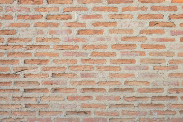 Background of old and dirty vintage orange dilapidated brick wall for background texture