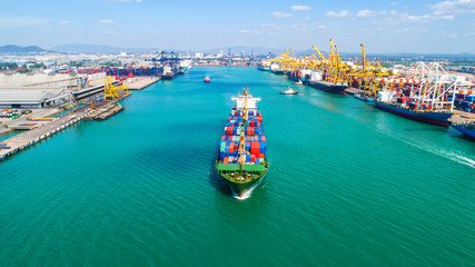 container ship in import export and business logistic.By crane ,Trade Port , Shipping.cargo to harbor.Aerial view.Top view. © MAGNIFIER
