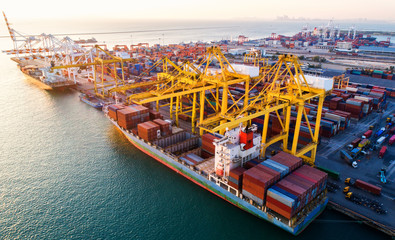 container ship in import export and business logistic.By crane ,Trade Port , Shipping.cargo to...