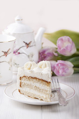 Biscuit cake with cream cheese cream on a white plate