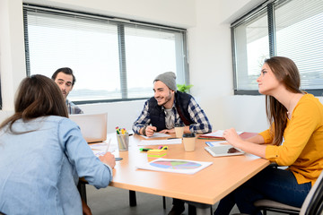 group of young cool hipster business people in casual wear working together in meeting room of a startup company