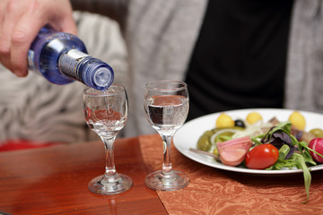 Person pouring vodka