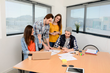 group of young cool hipster business people in casual wear working together in meeting room of a startup company