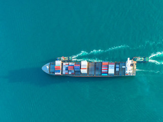 container ship in import export and business logistic.By crane ,Trade Port , Shipping.cargo to...