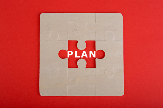 Jigsaw Puzzle Pieces with word "Plan" on red background