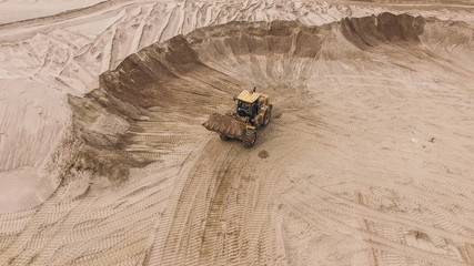 Aerial view of bulldozer on sand quarry