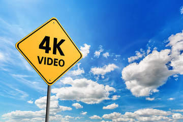 Blue cloudy sky and yellow road sign