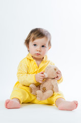 Portrait of a smiling child with a toy bear, isolated on a white background
