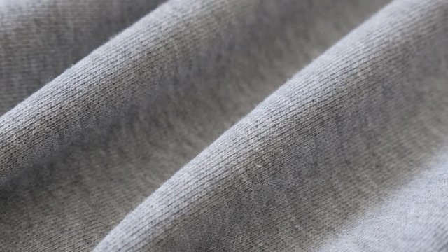 Panning on cotton training piece of cloth 2160p 30fps UltraHD footage - Gathers of fine sweating shirt or pants fabric texture close-up slow pan 4K 3840X2160 UHD video