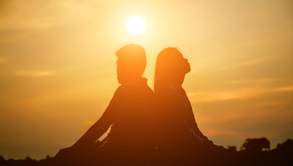 A man woman watching a sunset 