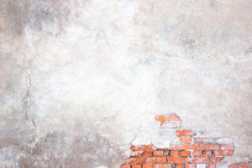 brick wall with damaged plaster, background shattered cement surface