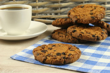 Coffee cup with oatmeal cookie chocolate on wooden background