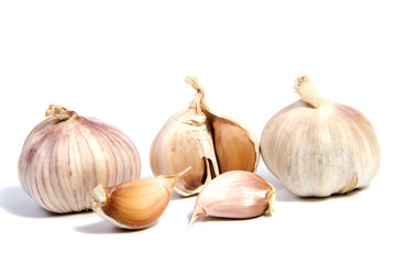 Fresh organic garlic and cutted garlic clove isolated on white background