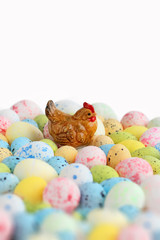 Easter chicken decor and colorful eggs on abstract light background. Easter holiday concept. beautiful seasonal composition. template for design