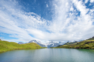 A magical landscape with a lake in the mountains in the Swiss Alps, Europe. Wetterhorn, Schreckhorn, Finsteraarhorn et Bachsee. ( relaxation, harmony, anti-stress - concept).