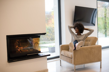 black woman in front of fireplace