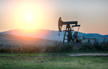 Naklejka premium oil pump on sunset
