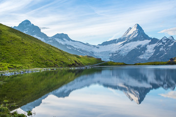 Naklejka na ściany i meble A magical landscape with a lake in the mountains in the Swiss Alps, Europe. Wetterhorn, Schreckhorn, Finsteraarhorn et Bachsee. ( relaxation, harmony, anti-stress - concept).