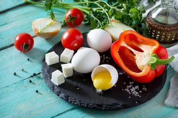 Ingredients for cooking egg omelette stuffed with red pepper and cheese. The concept of healthy nutrition and diet. Easy preparation of breakfast.